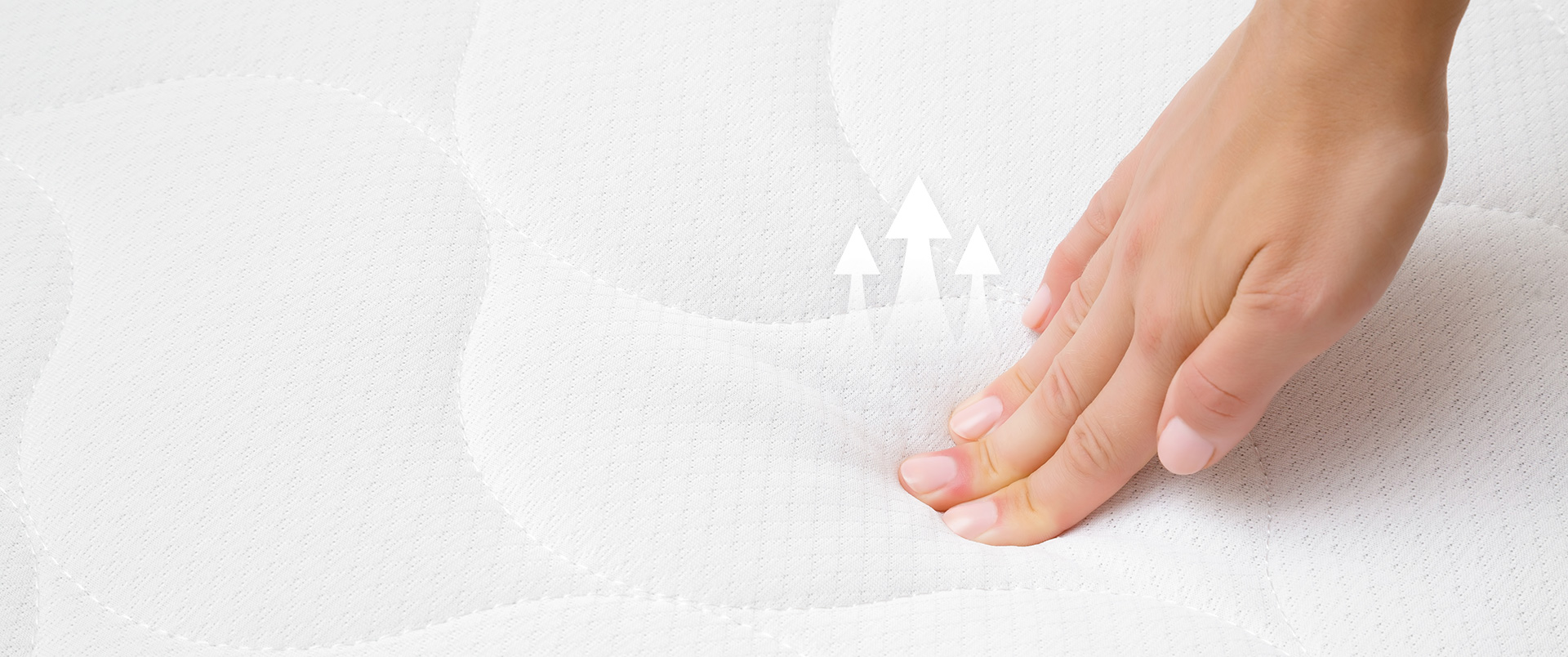 Feeling the cushioning of a quilted mattress